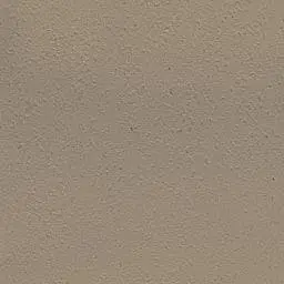 Close photograph of a warm beige plastered wall with a soft hand-finished texture.